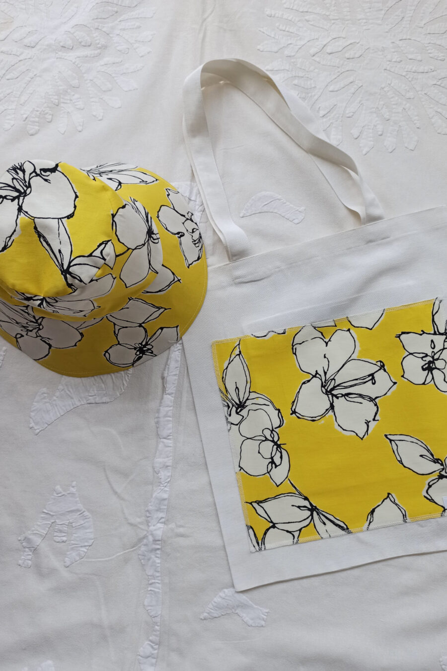 Yellow bucket hat in cotton with bag by pepperose n with floewrs in